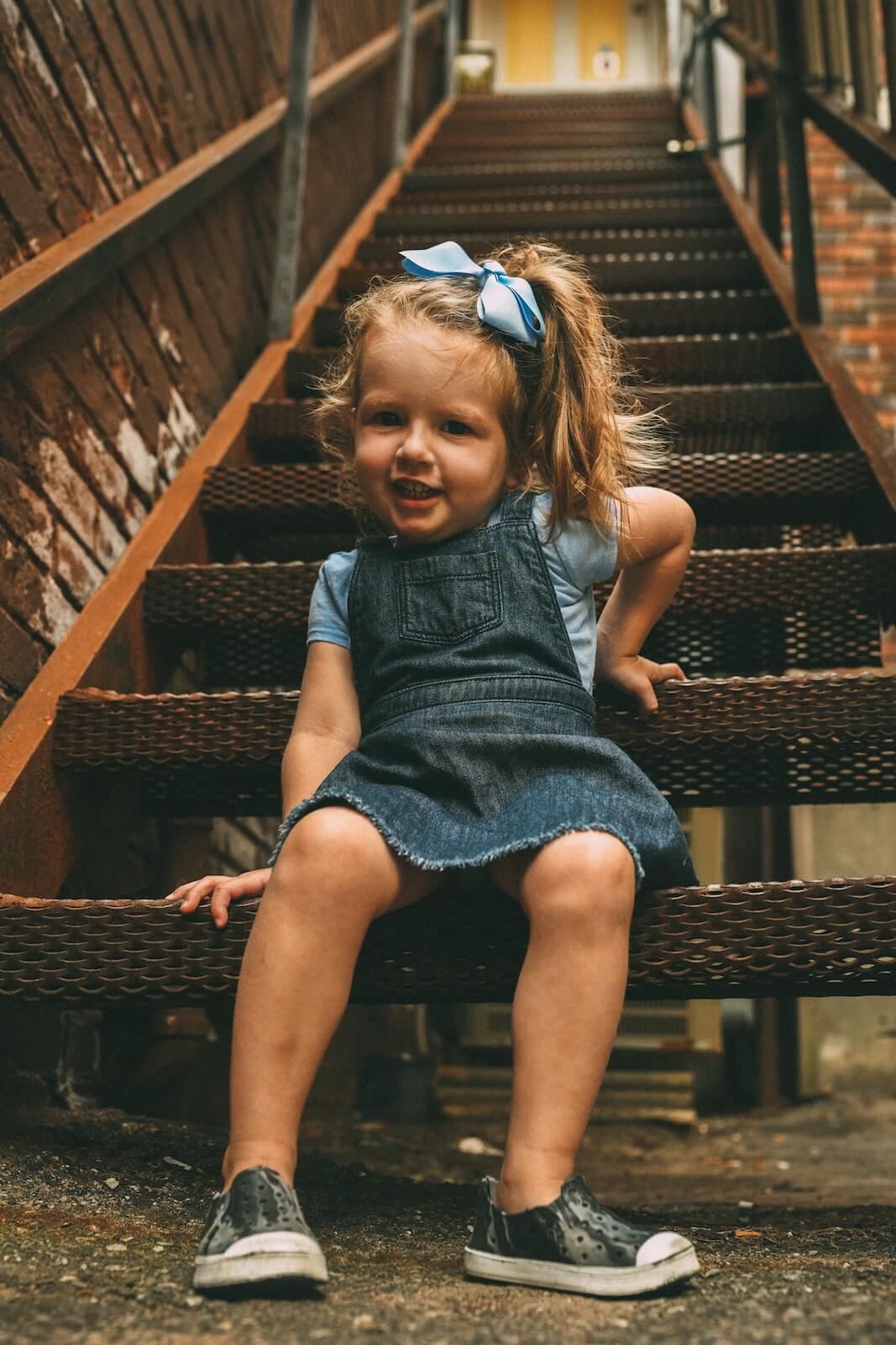 little girl sitting on stairs